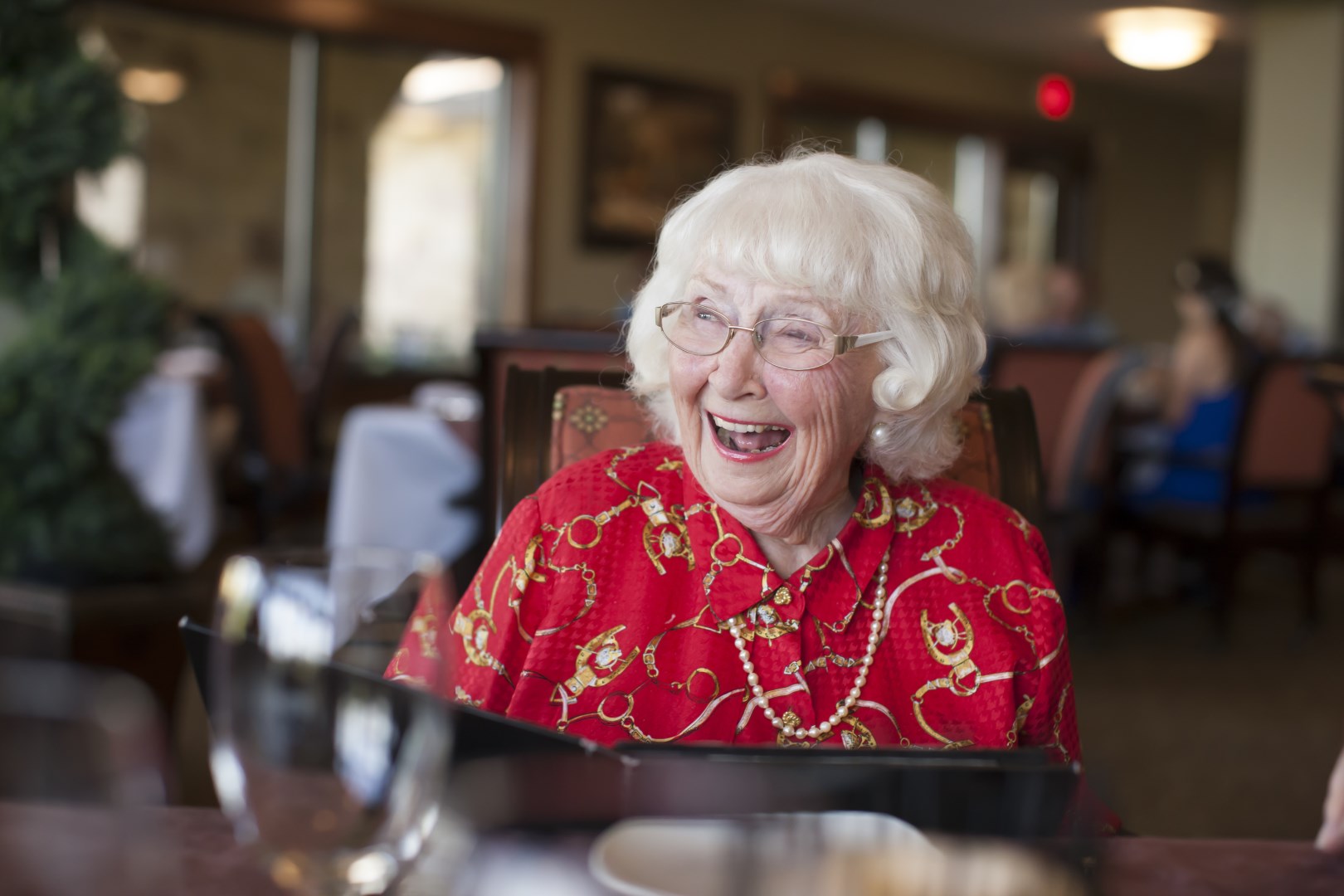 senior woman sitting at table in restaurant laugh 2022 03 07 23 56 08 utc
