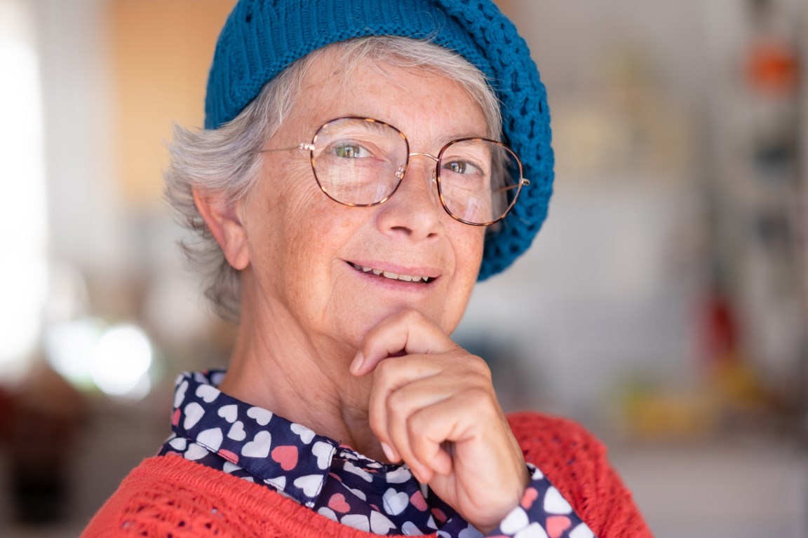 senior woman with hat smiling