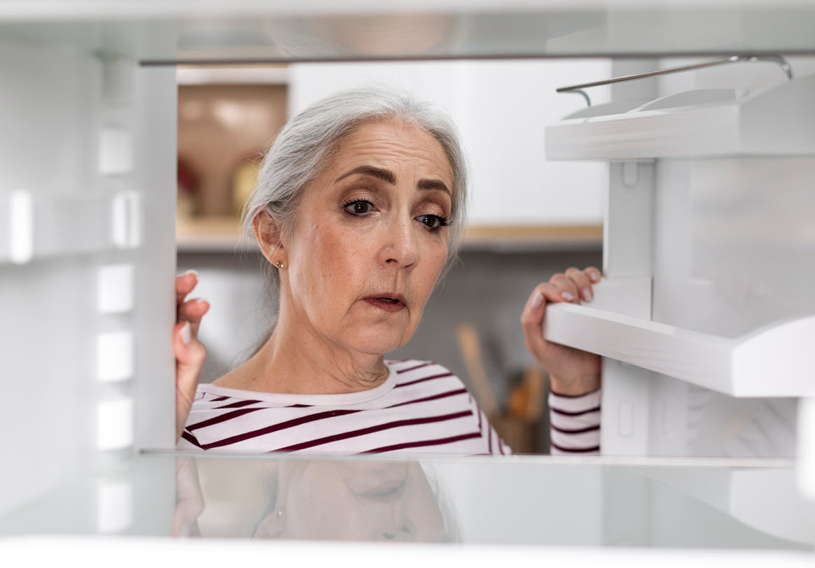 woman looking at moms fridge