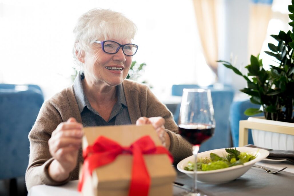 happy senior woman receiving gifts