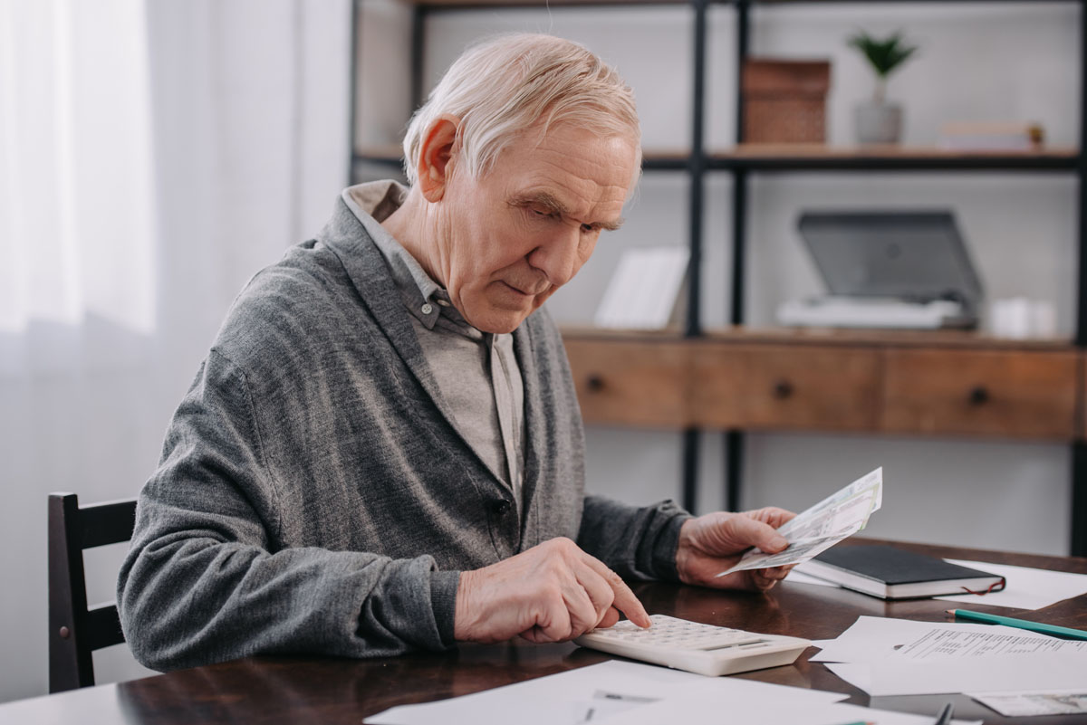Senior reviewing Medicare Supplement insurance documents at home