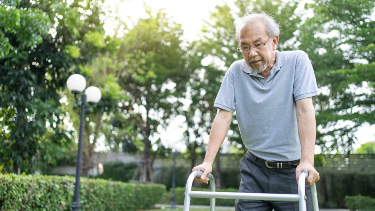 asian senior disabled man walking slowly