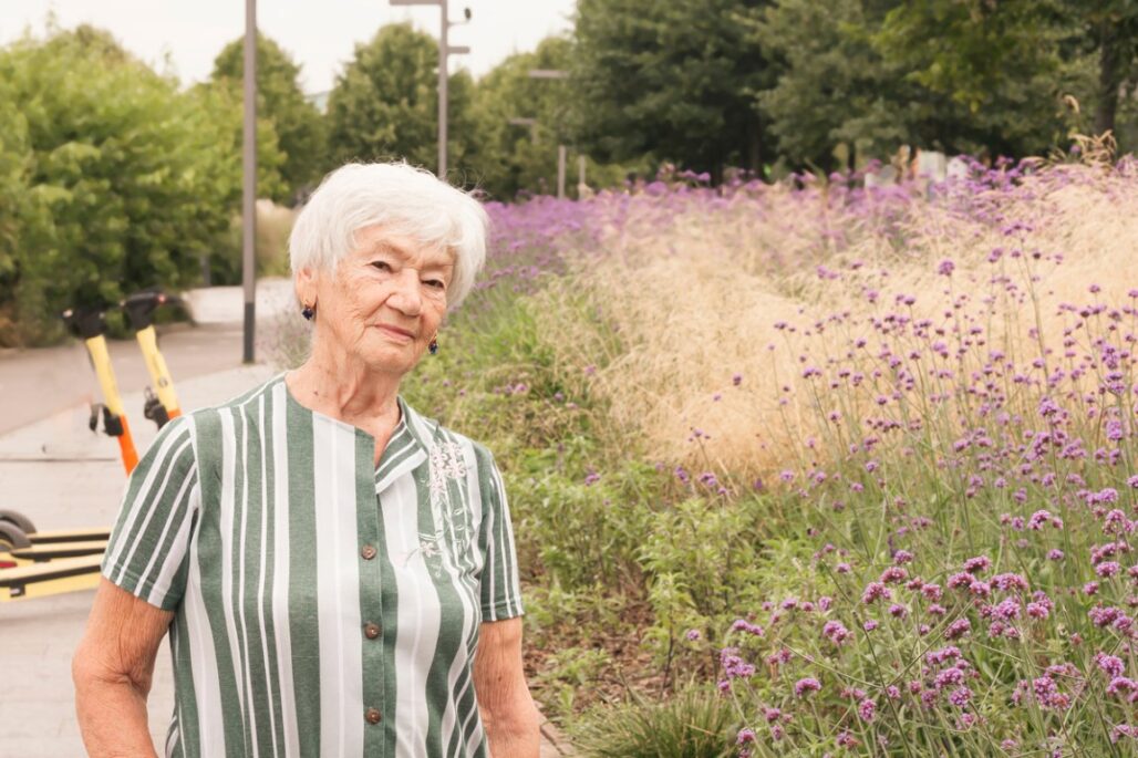 senior woman walking in the summer park