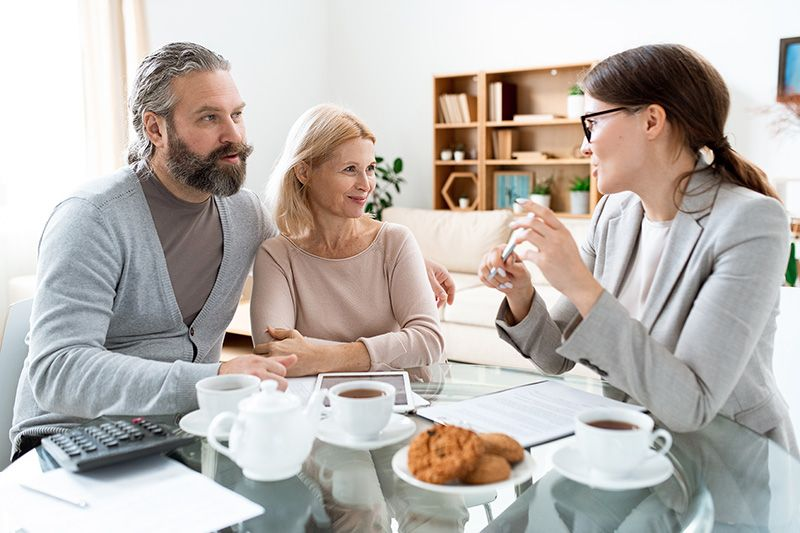 a man and woman converse with another woman